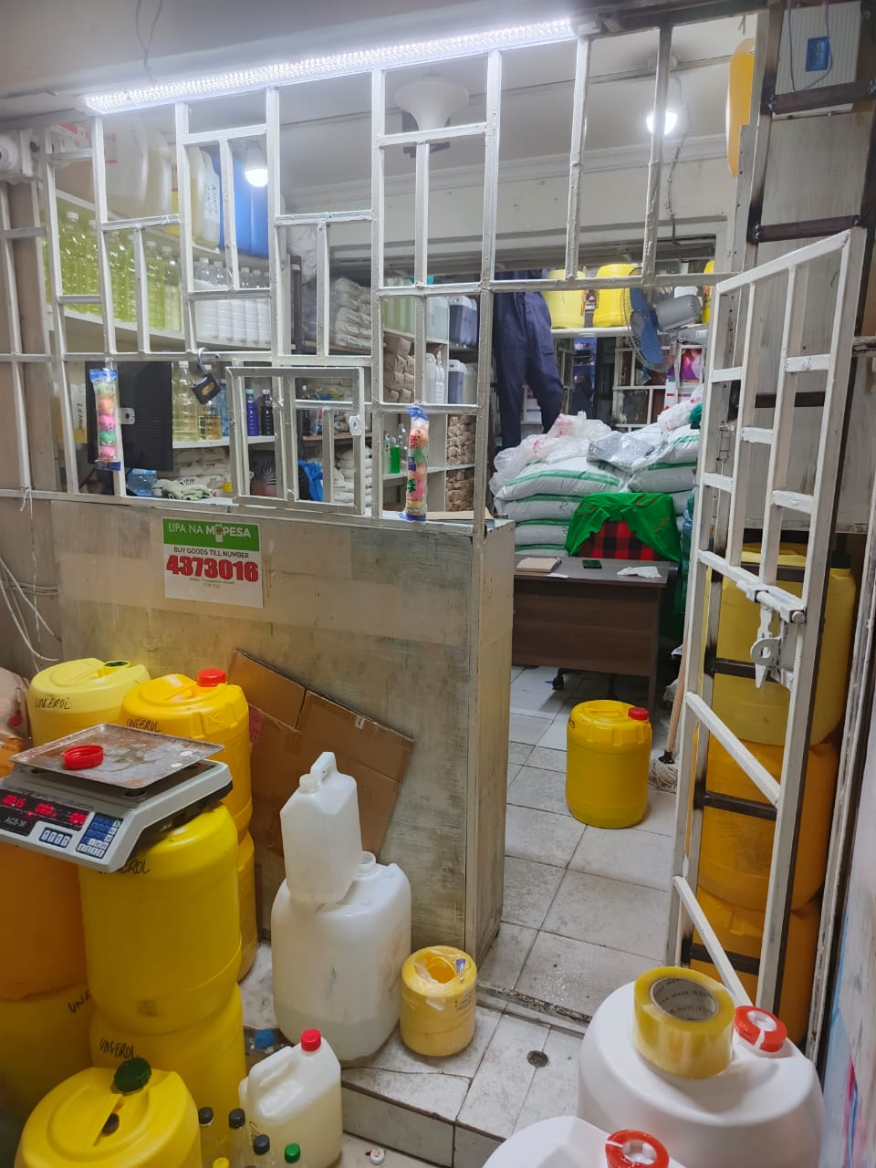 Inside the shop: bulk drums, sacks of salt, and shelves of bottled finished products