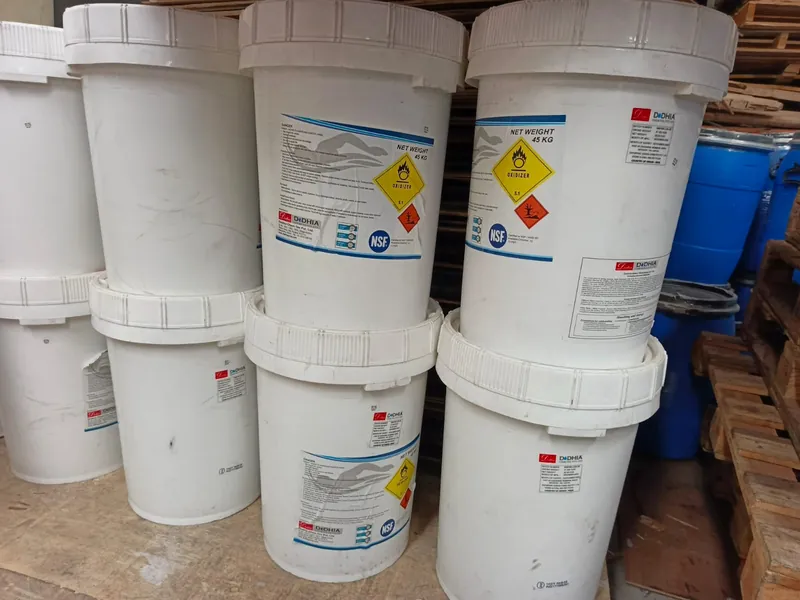 45 kg tubs of NSF-certified chlorine granules stacked in the store